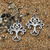 Stylized tree hook earrings with branches and roots curling into heart spirals