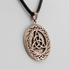 Wiccan jewelry close-up angled to the right, detailing the solid gold-colored finish and the continuous Celtic knot border surrounding the trinity knot