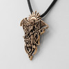 Gold dragon pendant close-up angled to the left, showing the meticulously sculpted scales, wings, and interwoven tribal details of the bronze dragon