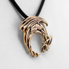 Bronze dragon pendant close-up angled to the right, highlighting the bright gold-colored finish and the intricately curved tail of this mythical creature necklace
