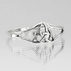 Angled view of a polished sterling silver Celtic knot triquetra ring featuring a split band