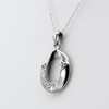 Celtic Teardrop necklace close-up angled to the right, showcasing the modern Triquetra pendant design and polished sterling silver finish