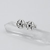 Pentacle post earrings shown in an artistic display on a clear quartz crystal point