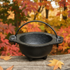 Baby Witch Cauldron: witchcraft supplies & wiccan ritual tools. Witches cauldron close up and outside, Samhain, natural light.