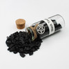 Black Tourmaline  amulet witch jar, pagan, wiccan, and witchcraft metaphysical store supplies with pentacle charm spilled on white witches altar.