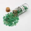 Green Aventurine amulet witch jar, pagan, wiccan, and witchcraft metaphysical store supplies with pentacle charm spilled on white witches altar.