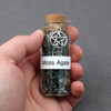 Moss agate green witchcraft amulet witch jar, pagan, wiccan, and witchcraft metaphysical store supplies with pentacle charm held in practitioners hand ready for spell work