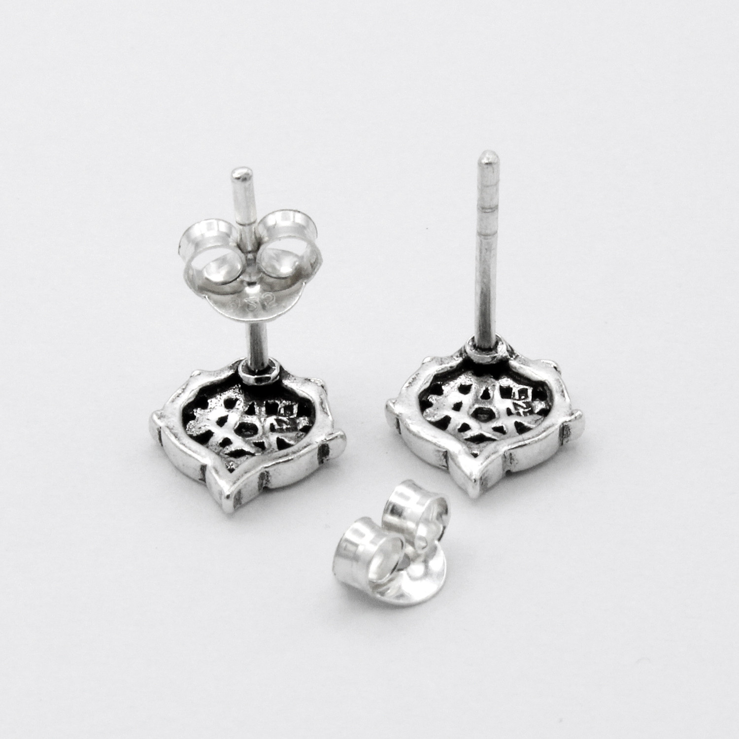 Back view of heart pentagram earrings showing the .925 silver hallmark, posts, and secure butterfly backings