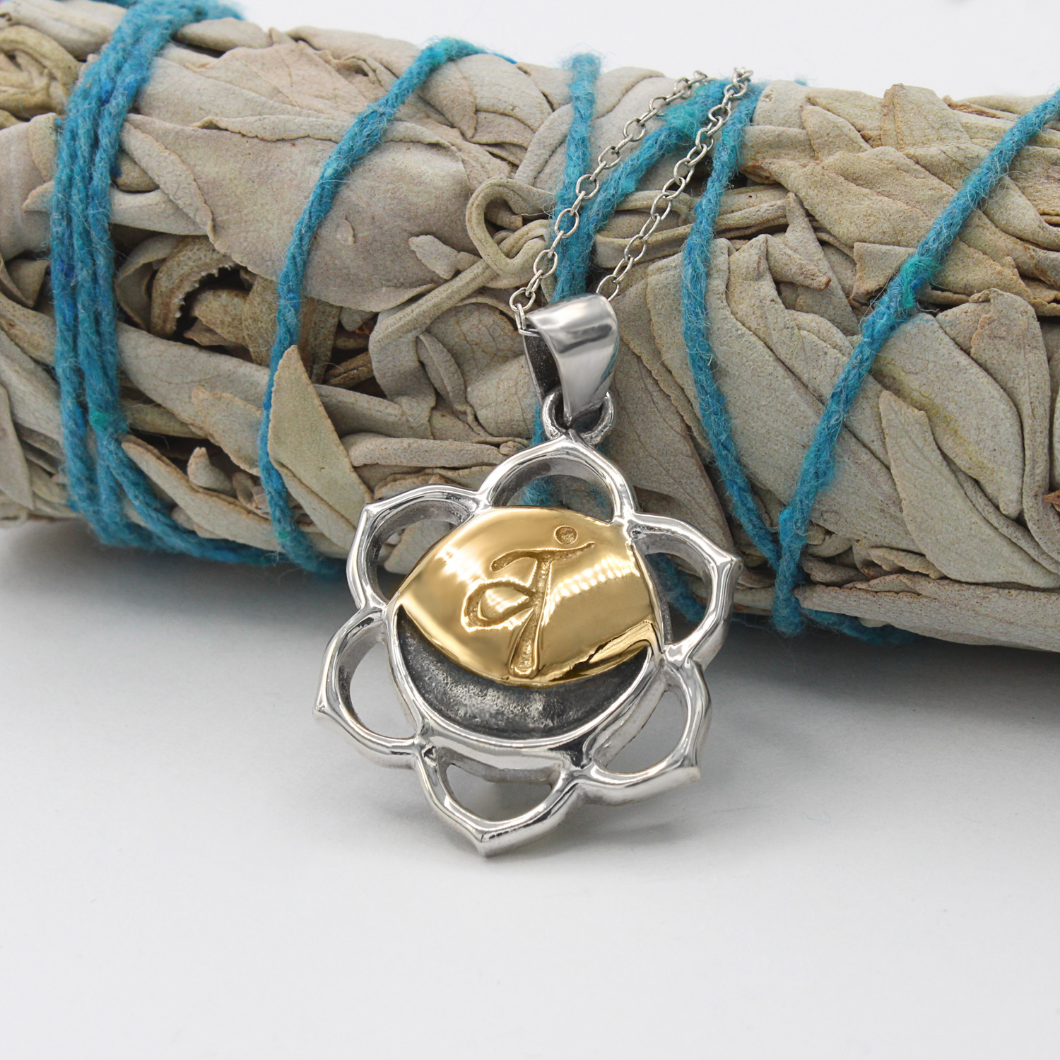 Svadhisthana necklace at our witchy supply store with a six-petaled sterling silver frame and a golden crescent moon center