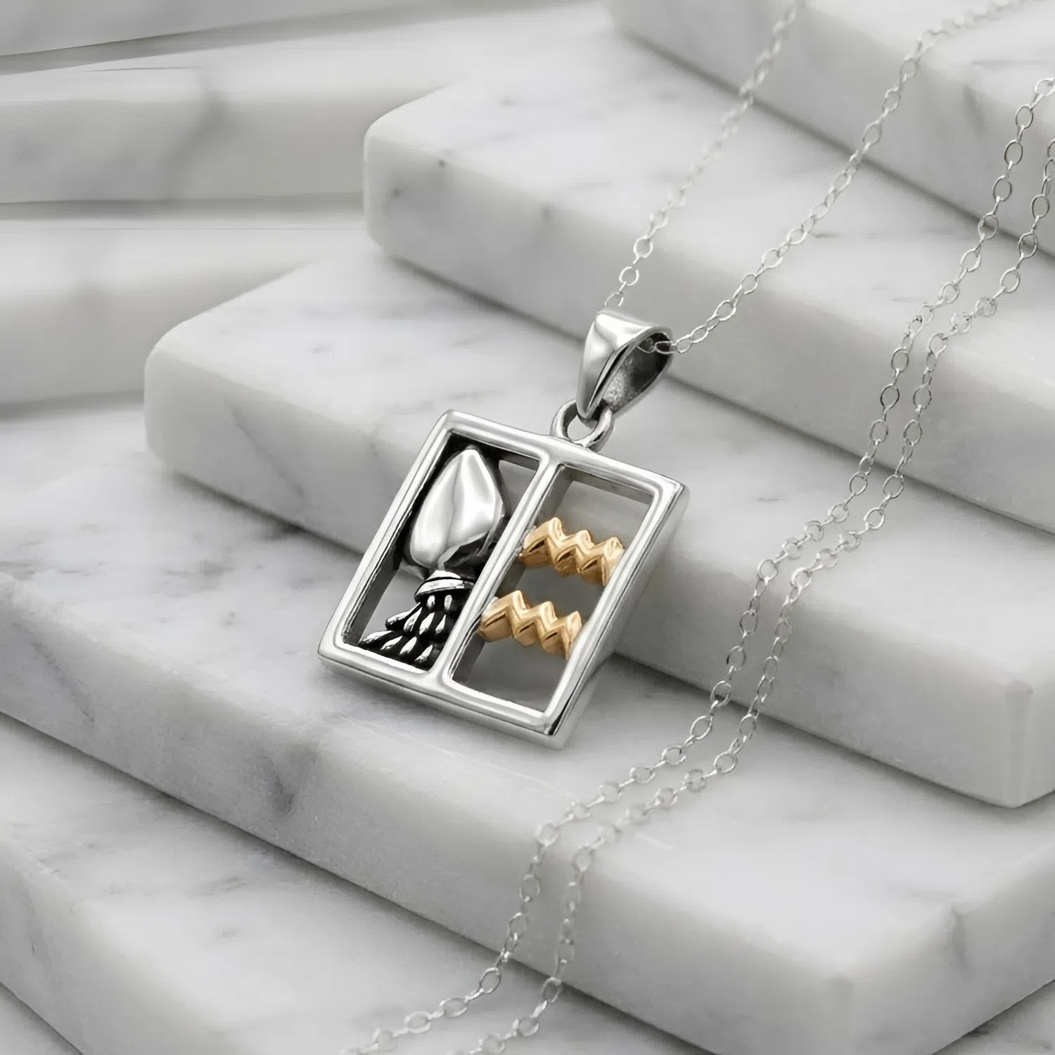 Sterling silver Aquarius: Horoscope pendant featuring a water pitcher and gold waves resting on white marble