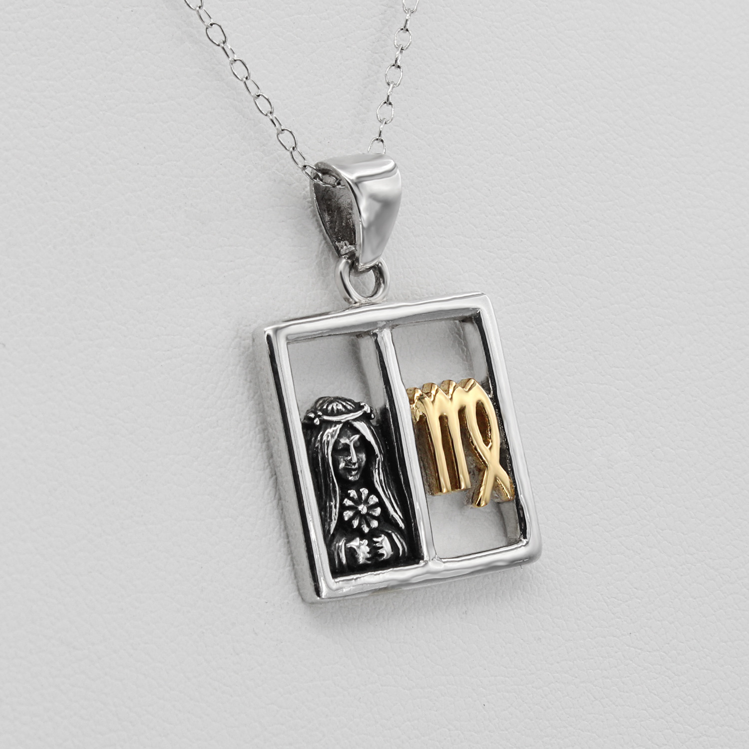Virgo necklace horoscope jewelry featuring a balanced split-window design with a three-dimensional silver maiden and a polished gold Virgo symbol