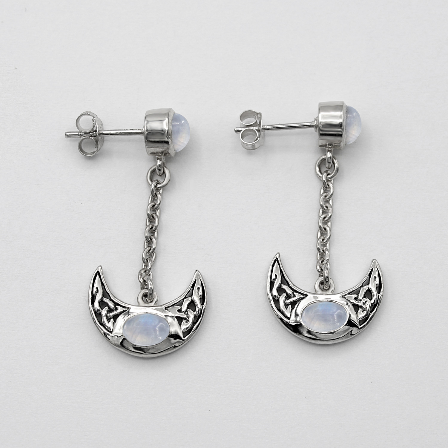 Celtic moon earrings in .925 sterling silver featuring a rainbow moonstone stud and a dangling Wiccan crescent moon