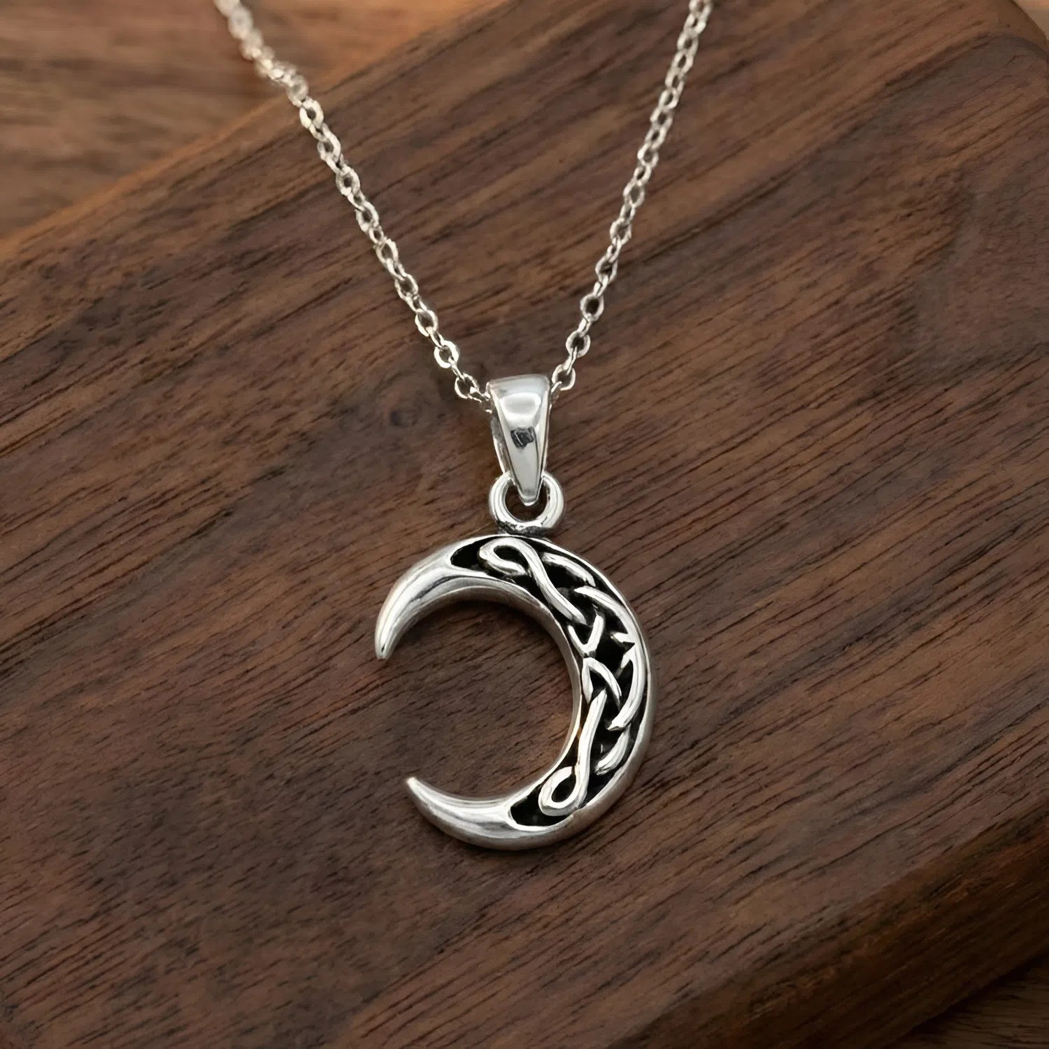 Sterling silver crescent moon pendant with traditional Celtic knots