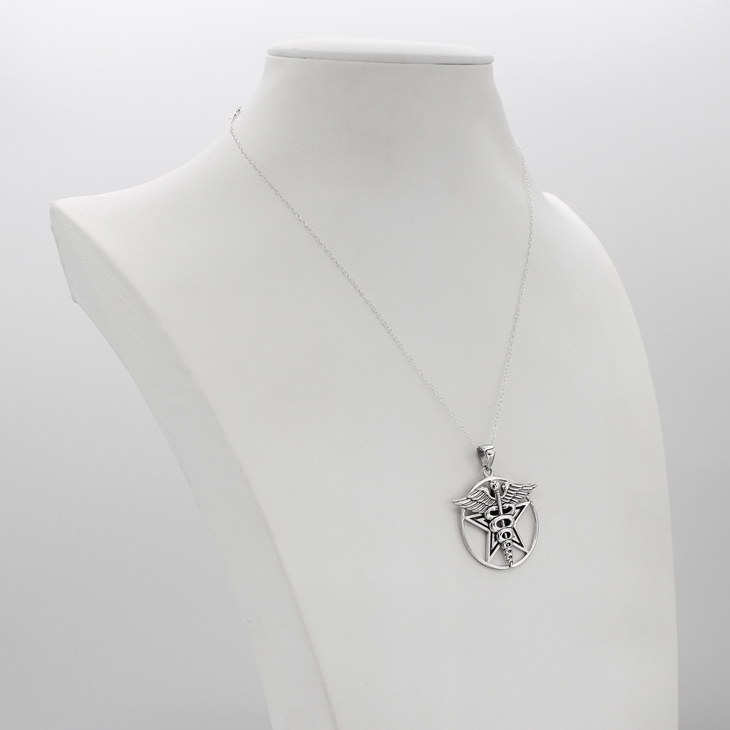 Asclepius necklace and pentacle pendant serving as a healers pentagram, this beautiful sterling silver amulet is displayed elegantly on a white jewelry bust