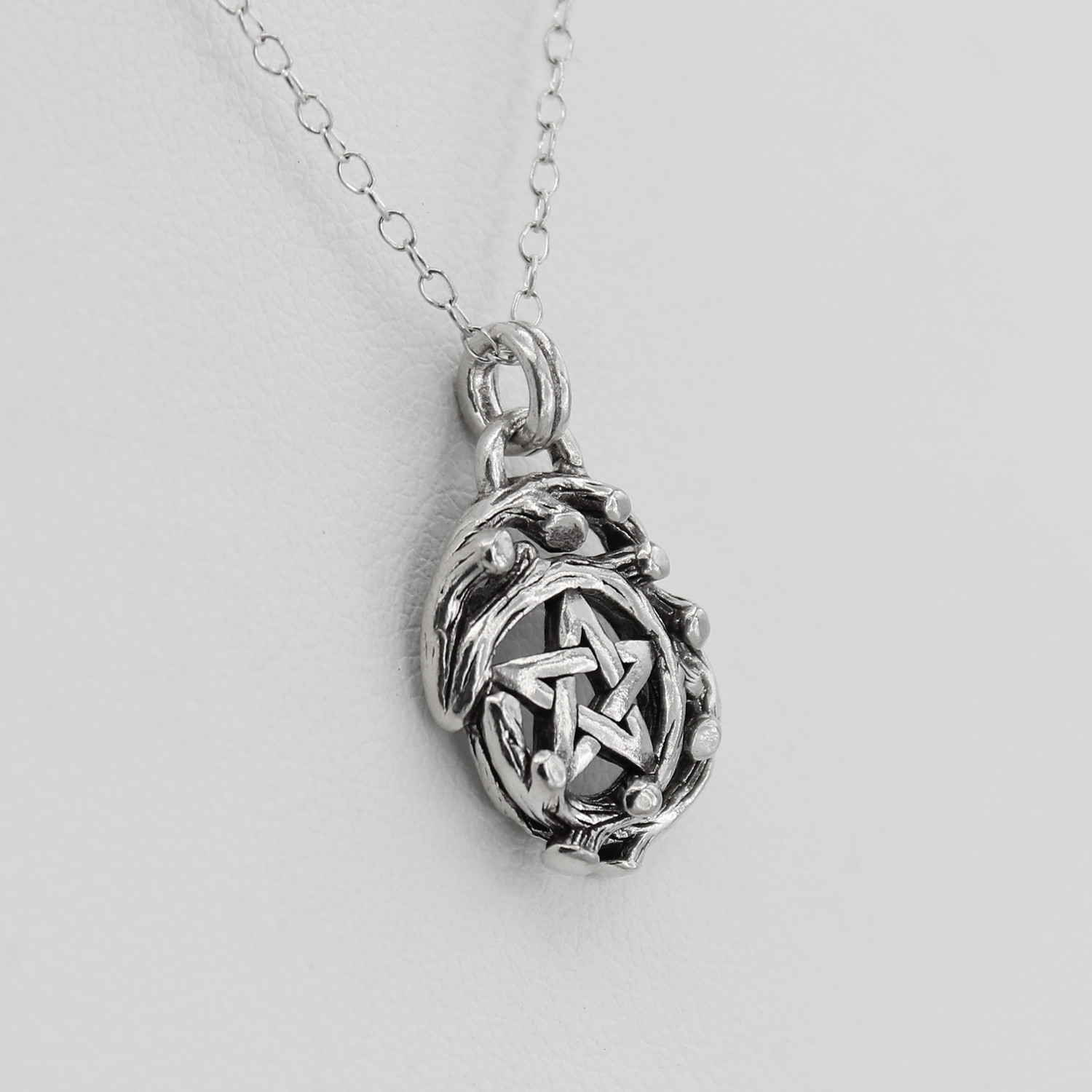 Druid necklace and pentacle shown from a close right angle, highlighting the detailed Celtic elements of this sterling silver amulet