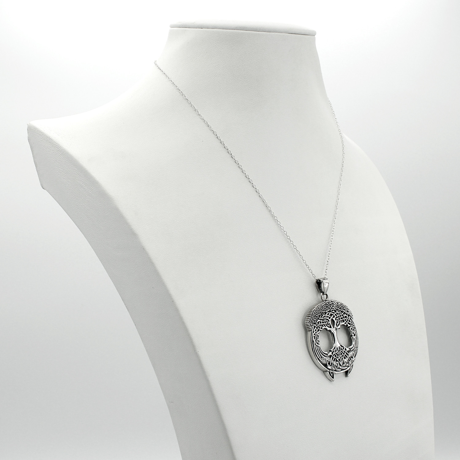 Large tree of life showcased gracefully on a white jewelry bust at our pagan jewelry store, a substantial Celtic tree pendant and sterling silver tree pendant perfect for daily wear