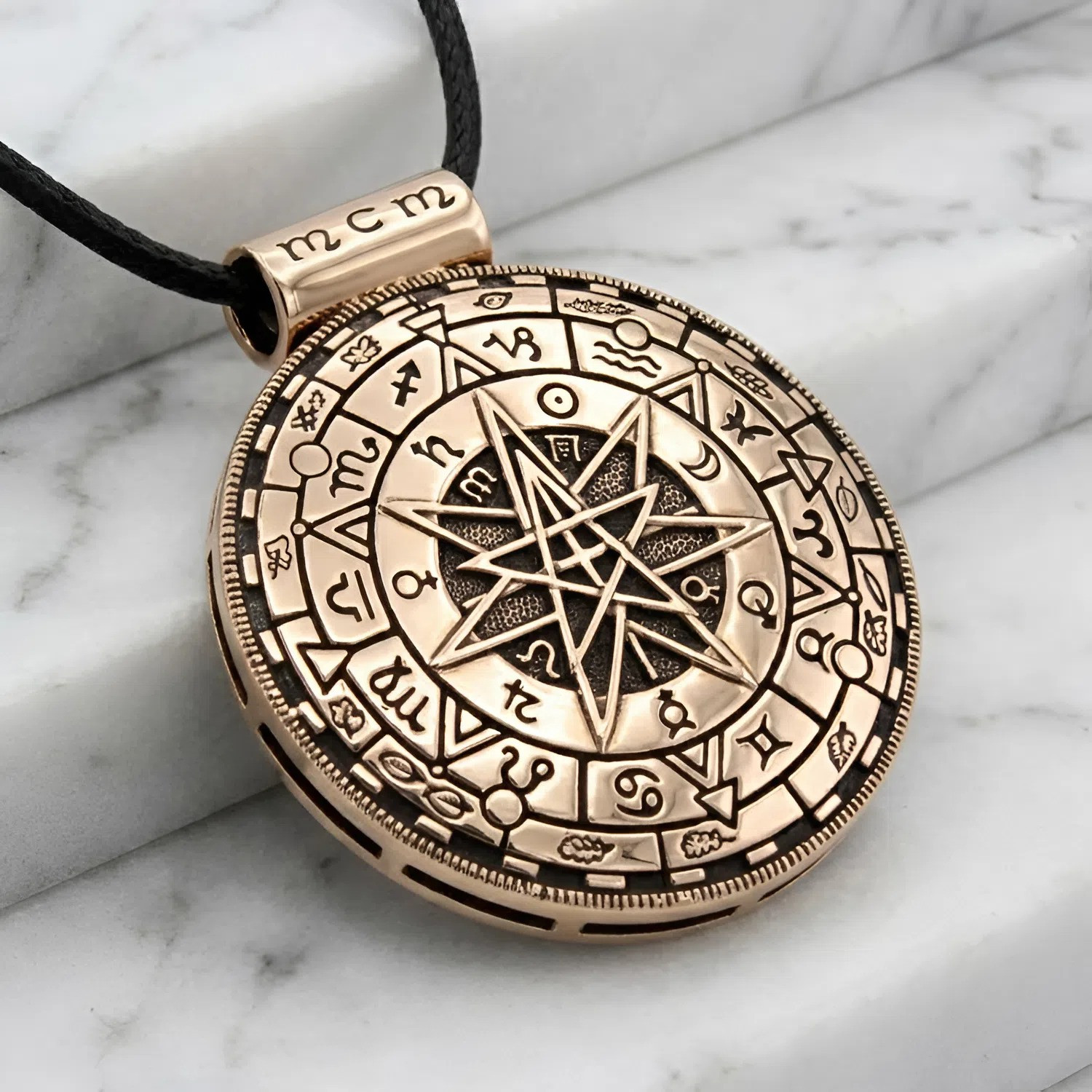 Large Magic Symbol Pendant crafted in gold-colored bronze, resting elegantly on white marble steps to highlight the intricately carved zodiac border