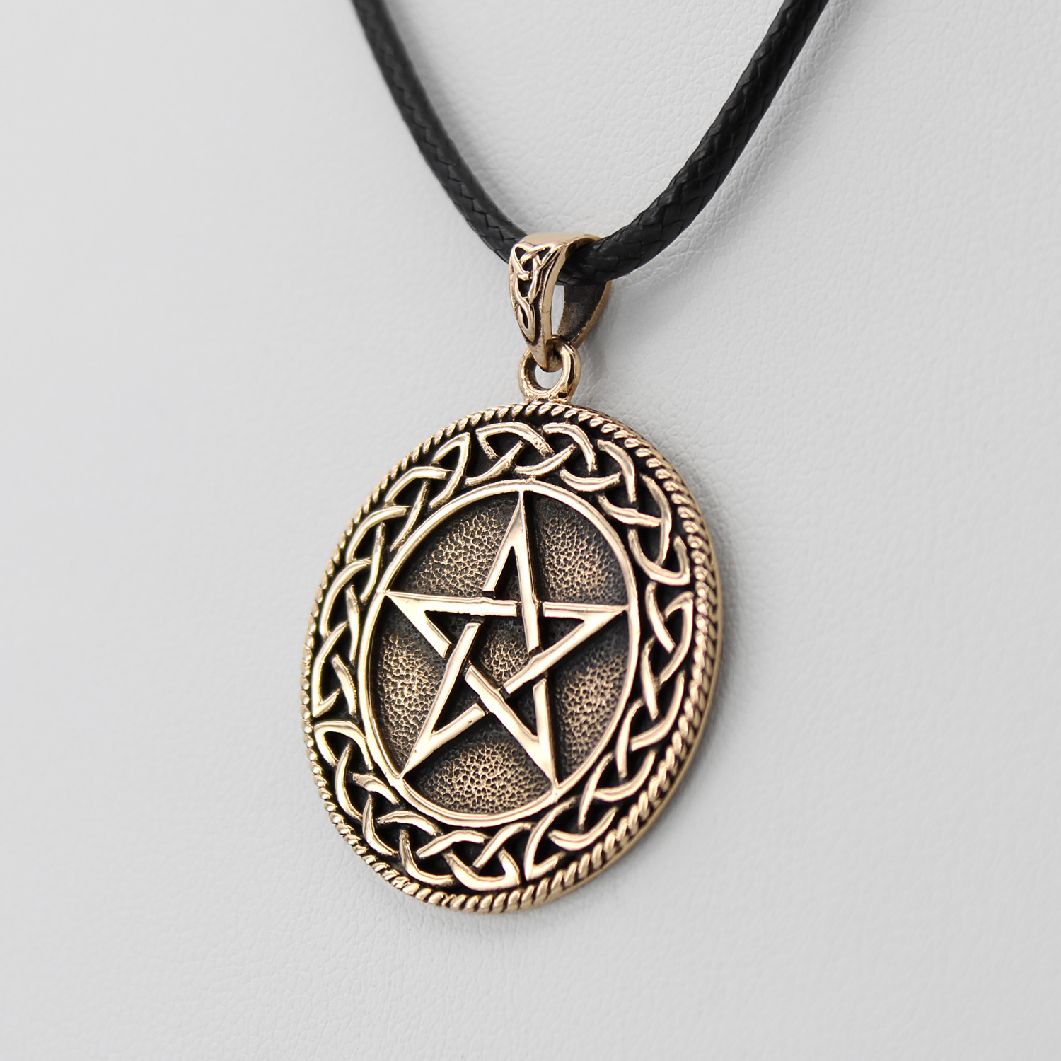 Witch pentagram close-up angled to the right, showing the brilliant gold-tone finish and the deep etched background of this solid Celtic pentacle necklace