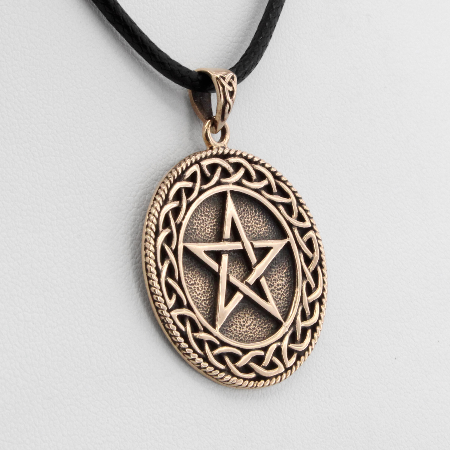 Druid pentagram close-up angled to the left, showing the beautiful intertwining details of the Celtic knot border framing the central star
