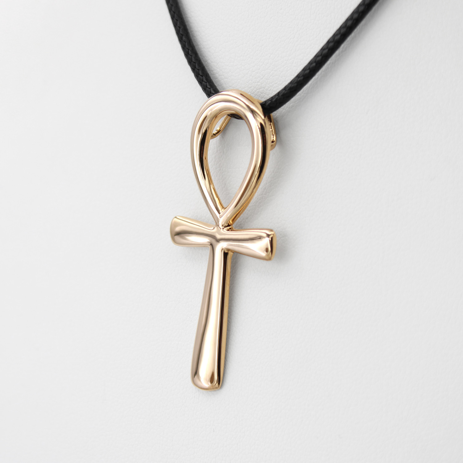 Gold Ankh pendant close-up angled to the left, showing the flawless, polished surface and minimalist design of the Egyptian cross