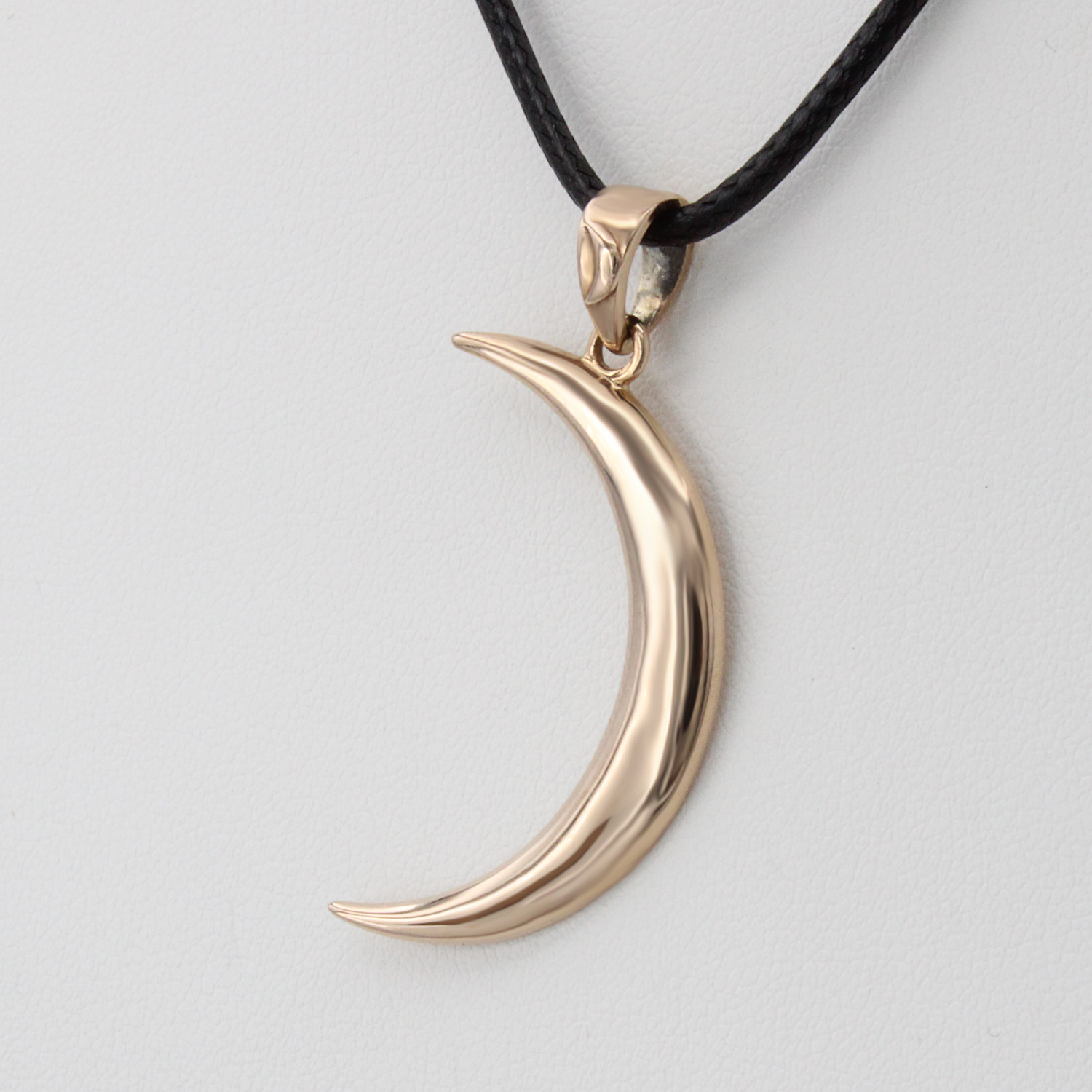 Gold crescent moon necklace at our Wicca store close-up angled to the right, highlighting the simple yet elegant celestial design of this piece of witch jewelry