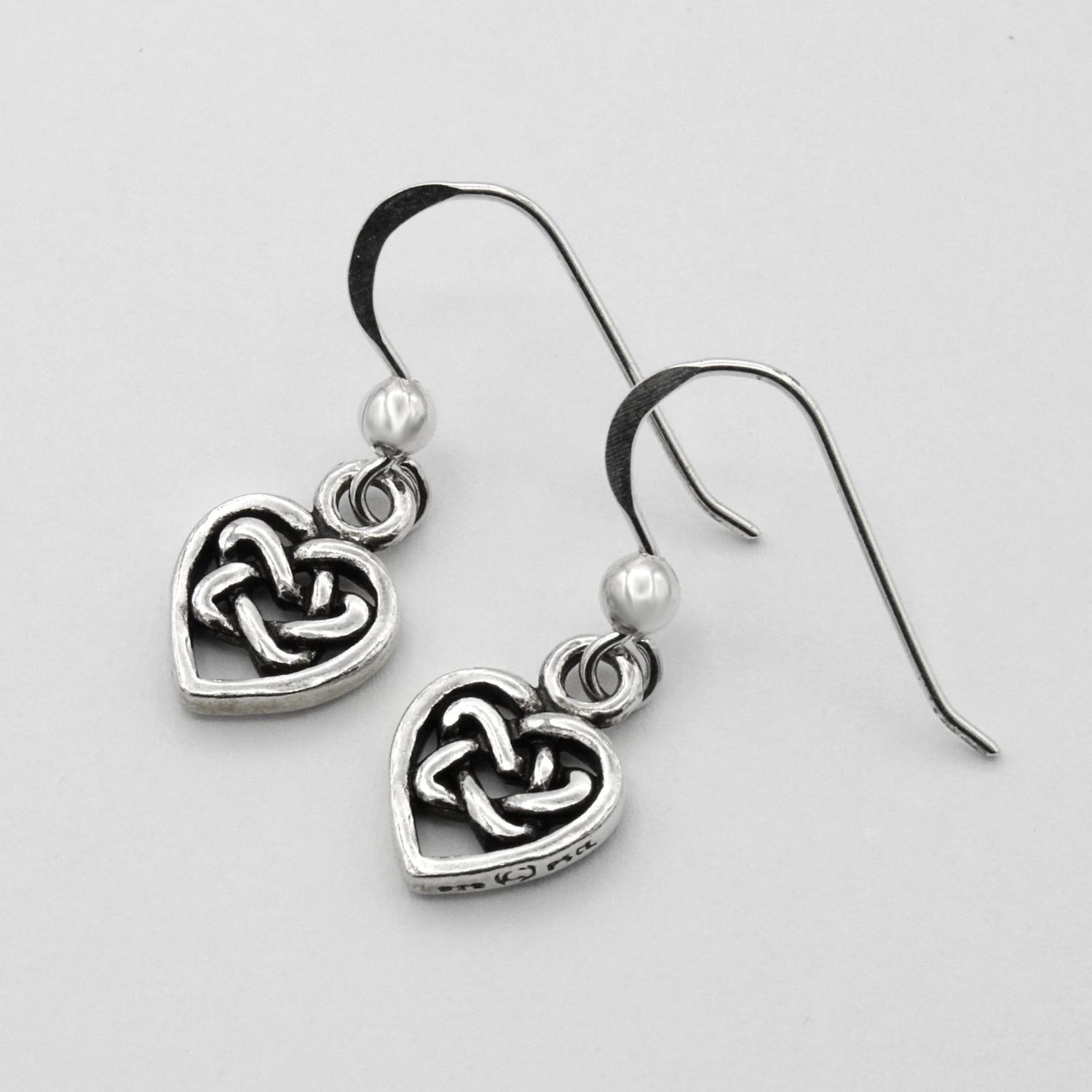 Hidden Pentacle Heart Earrings Made From Sterling Silver Laying Flat
