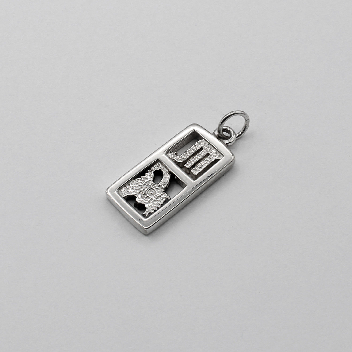 .925 sterling silver back view of the Scorpio charm showcasing the hallmark and textured finish