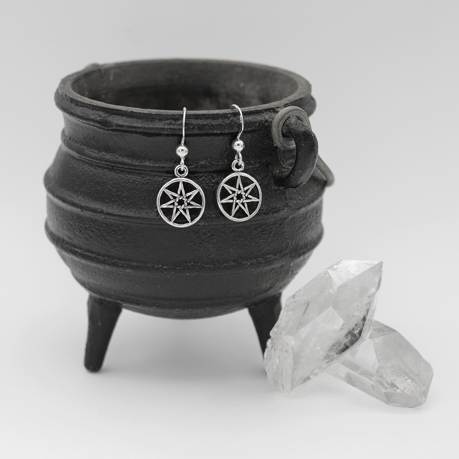 Silver Fairy Star Earrings Hanging on Cauldron