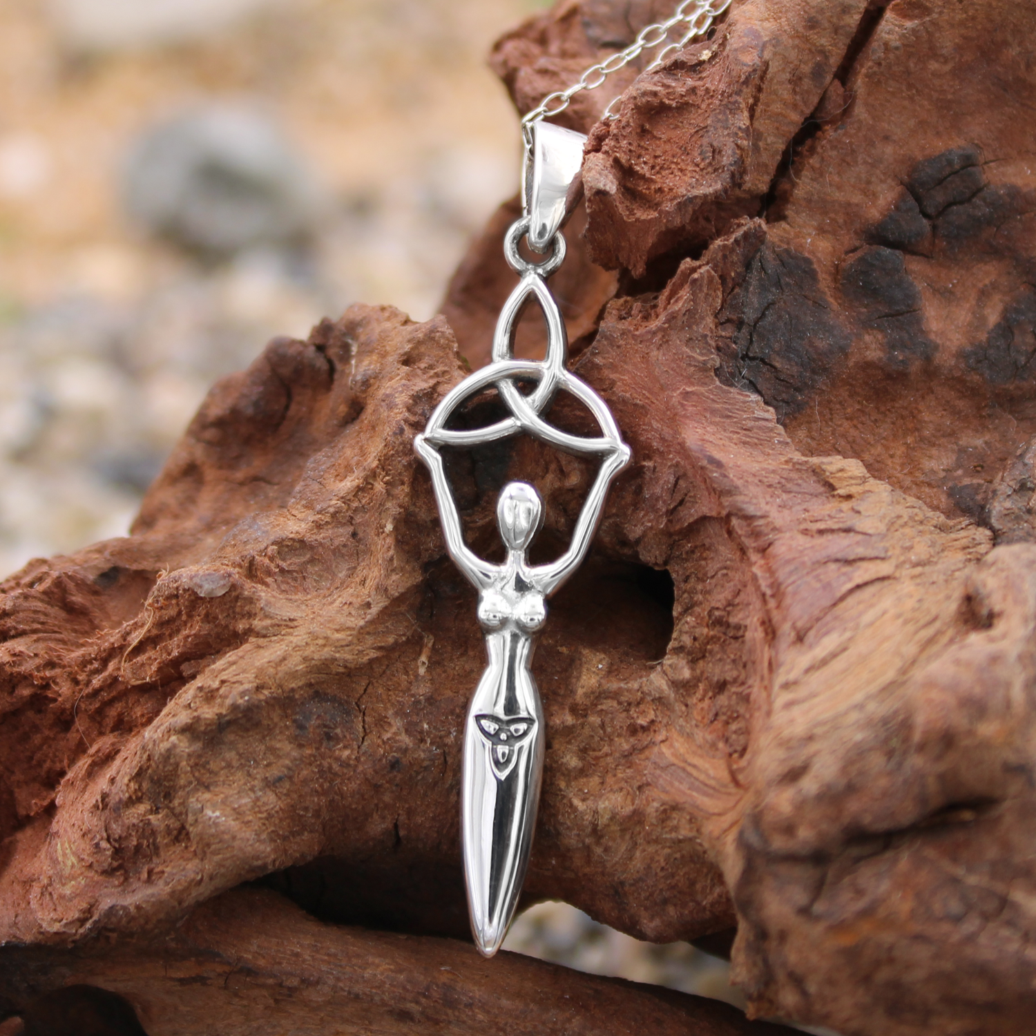 Sterling silver Celtic goddess pendant necklace on driftwood at our pagan jewelry store