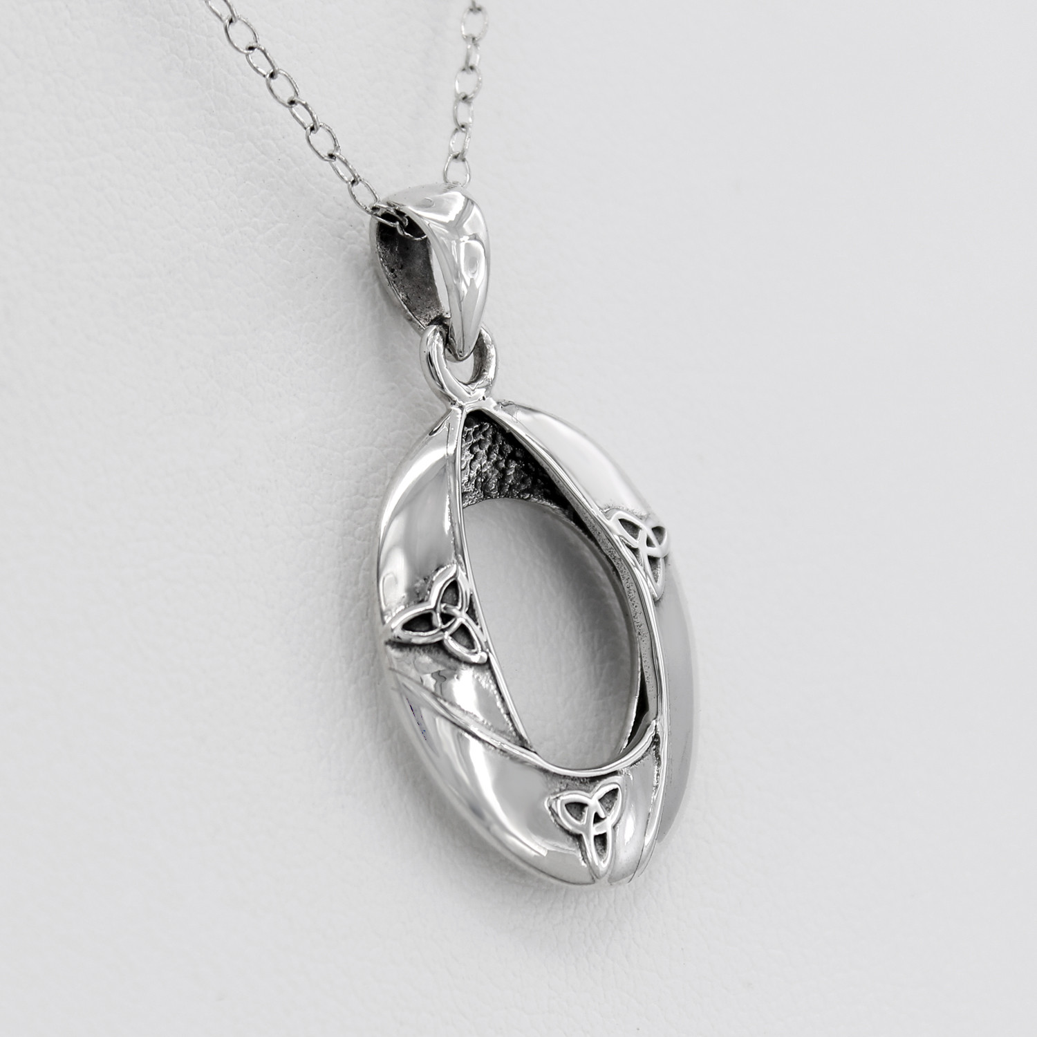 Pagan jewelry in .925 sterling silver, featuring a close-up left angle of the modern Celtic trinity knot pendant against a white background