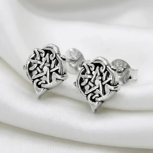 Wiccan heart pentacle post earrings resting on elegant white silk for a romantic, pagan jewelry aesthetic