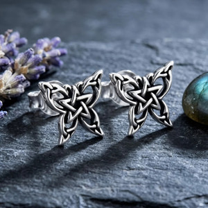 Pentagram earrings: Butterfly pentagram studs in .925 sterling silver resting on dark slate with lavender displayed at our Pagan store