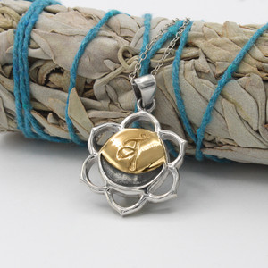 Svadhisthana necklace at our witchy supply store with a six-petaled sterling silver frame and a golden crescent moon center