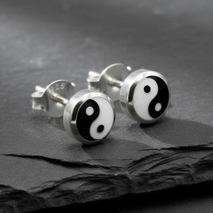 Yin Yang stud earrings for women, showcasing small, polished .925 sterling silver bezels resting elegantly on a dark, textured slate surface