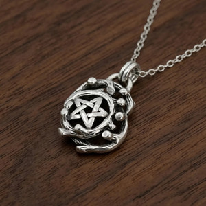 Celtic pentagram captured on a rustic wood background, a striking Druid Pendant and pentacle necklace cast in solid sterling silver at our Wicca supply store