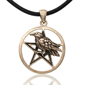 Raven pentacle pendant in a polished gold-tone bronze, featuring a 3D sculpted crow perched on a pentagram against a bright white background with a soft reflection