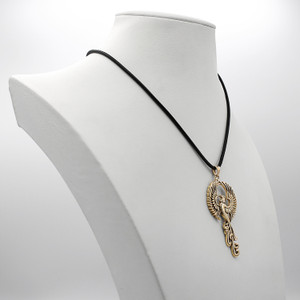 Gold phoenix pendant displayed on a white jewelry bust, showcasing the black cord and the impressive hanging scale of the elegant firebird necklace