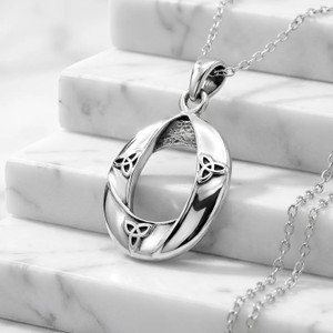 Modern Triquetra pendant at our pagan jewelry store in .925 sterling silver, featuring a Celtic teardrop design resting elegantly on white marble steps