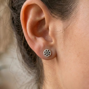 Septagram earrings functioning as delicate faery star studs, worn comfortably on a model's earlobe for a minimalist, mystical look