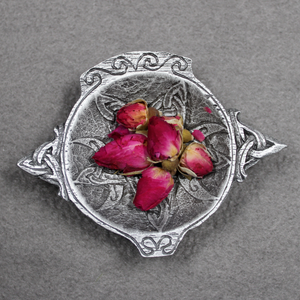 The Red Rose Buds Witchcraft Essentials Apothecary Bag, containing witchcraft supplies and spell ingredients, is shown inside a ritual offering bowl. The Red Rose Buds Witchcraft Essentials Apothecary Bag, containing witchcraft supplies and spell ingredients, is shown inside a ritual offering bowl.
