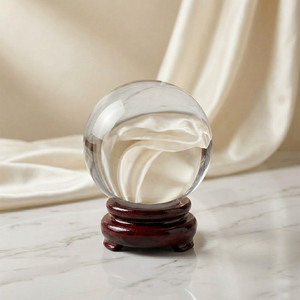 4 inch crystal ball with wooden stand and cream backdrop