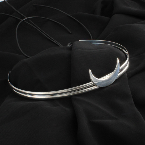 Embrace the lunar energies with this beautifully crafted ritual circlet. This sterling silver crown, an essential amongst Wicca tools and supplies, showcases a sleek and polished crescent moon, a timeless symbol of magic and femininity. As a piece of occult apparel, it effortlessly complements any witchcraft aesthetic outfit, adding a touch of celestial allure to your modern day witch clothing & accessories.