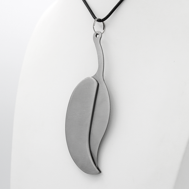 A ritual boline necklace with a polished stainless steel leaf blade on white altar or table, highlighting the purpose of the ceremonial witchcraft knife. A ritual boline necklace with a polished stainless steel leaf blade on white altar or table, highlighting the purpose of the ceremonial witchcraft knife.