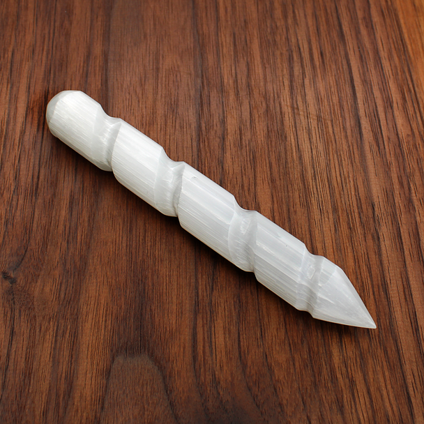 Close-up of Satin Spar Selenite point showing the fibrous 'liquid light' texture and smooth spiral carving.
