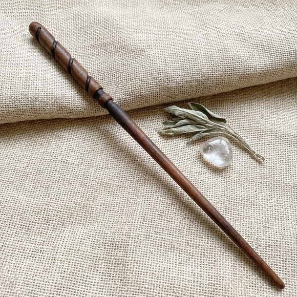 Magical wand resting on burlap read for magick and ritual use.