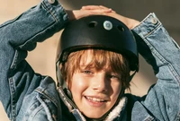 A Lost and Found Label on a child's black helmet.