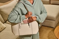 Image of Tile Slim - Blush being placed inside of a purse