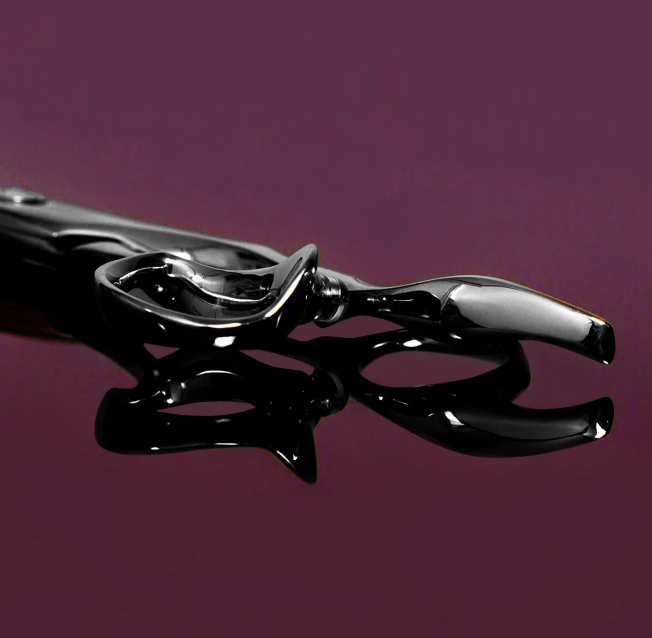 Sliver scissor handle showing the curved thumb and tang.