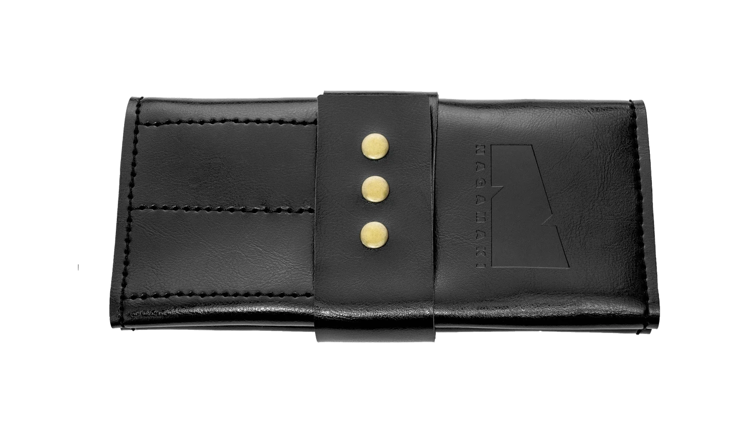 A black leather scissor case with gold buttons and the Nagamaki logo on ther front