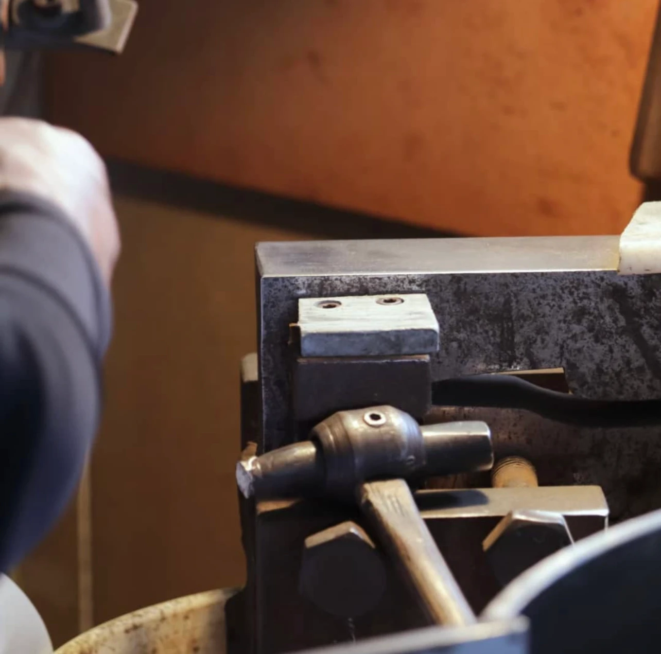 a picture of a blades smiths hammer and work area